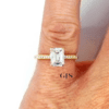 emerald cut diamond engagement ring set with small side stones