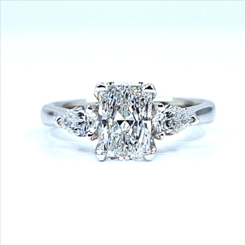 Radiant cut diamond engagement ring with two pear-shaped side diamonds set in white gold