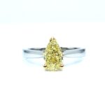 Natural fancy yellow pear-shaped diamond set on a minimalist white gold band, custom made by Geretti Jewellery Sablon
